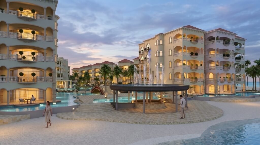 Luxury beachfront resort entrance rendering featuring an illuminated fountain plaza, Mediterranean-style architecture, beachfront promenade, and lagoon pools.