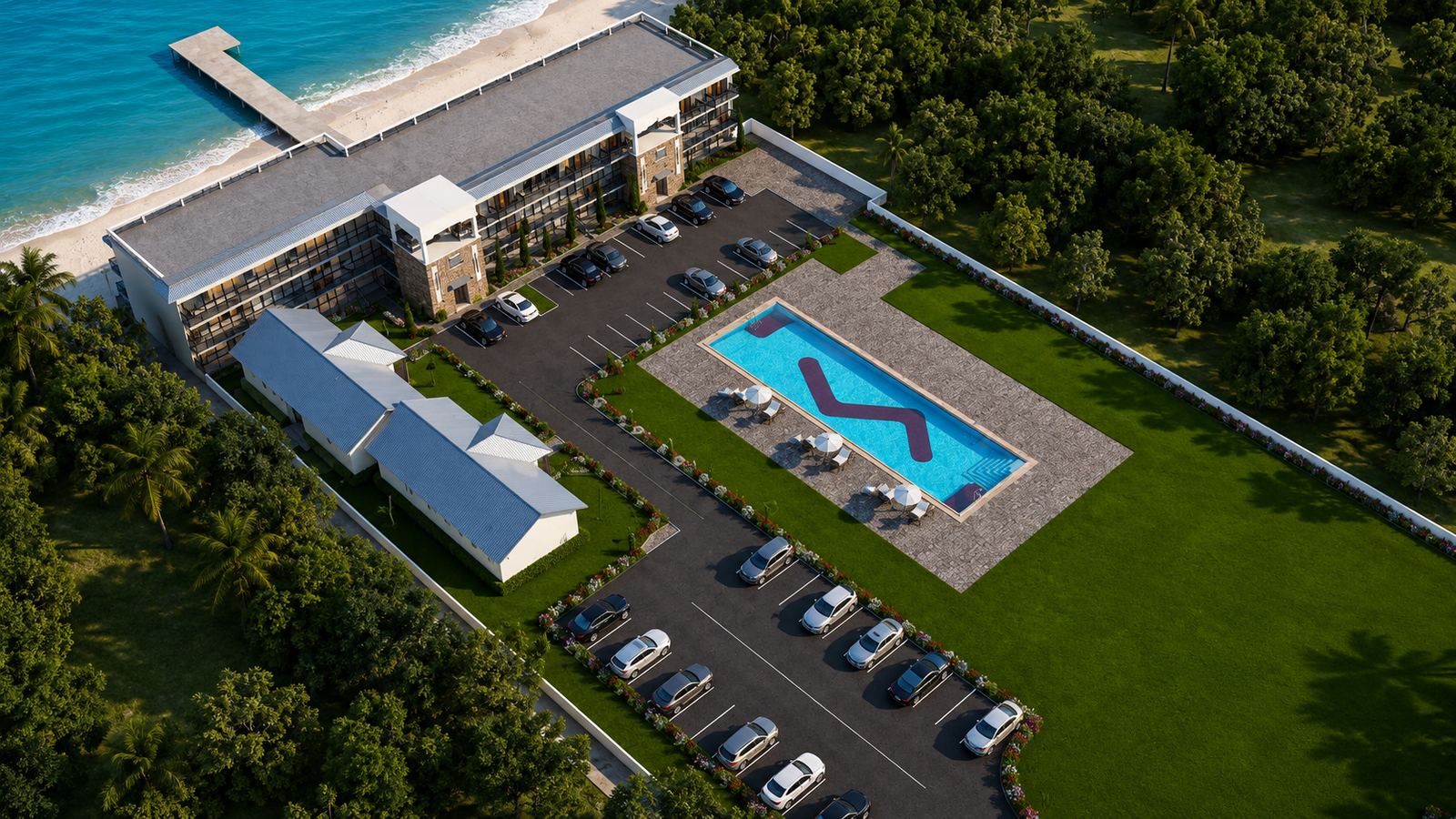 Aerial bird's-eye view of motel property showing pool, parking, landscaping and surrounding green space