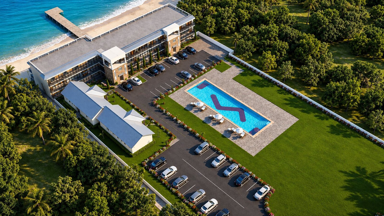 Aerial bird's-eye view of motel property showing pool, parking, landscaping and surrounding green space