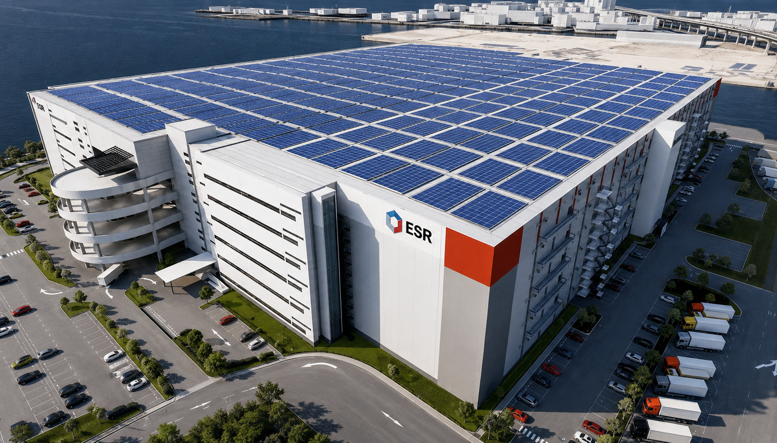 Industrial warehouse with solar panels on rooftop and parking lot viewed from above