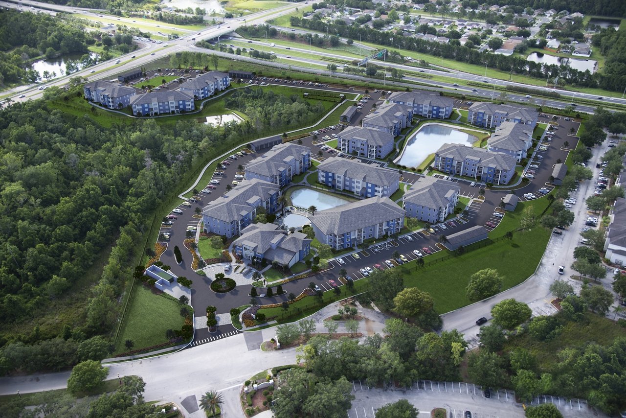 Aerial site plan rendering showing entire development with building footprints, parking, and landscape layout