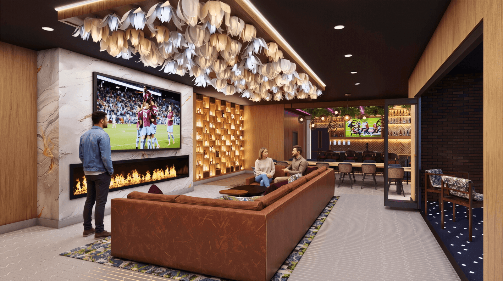 Modern lounge interior with fireplace, large TV sports screen, decorative ceiling lights, and people relaxing on sofas.