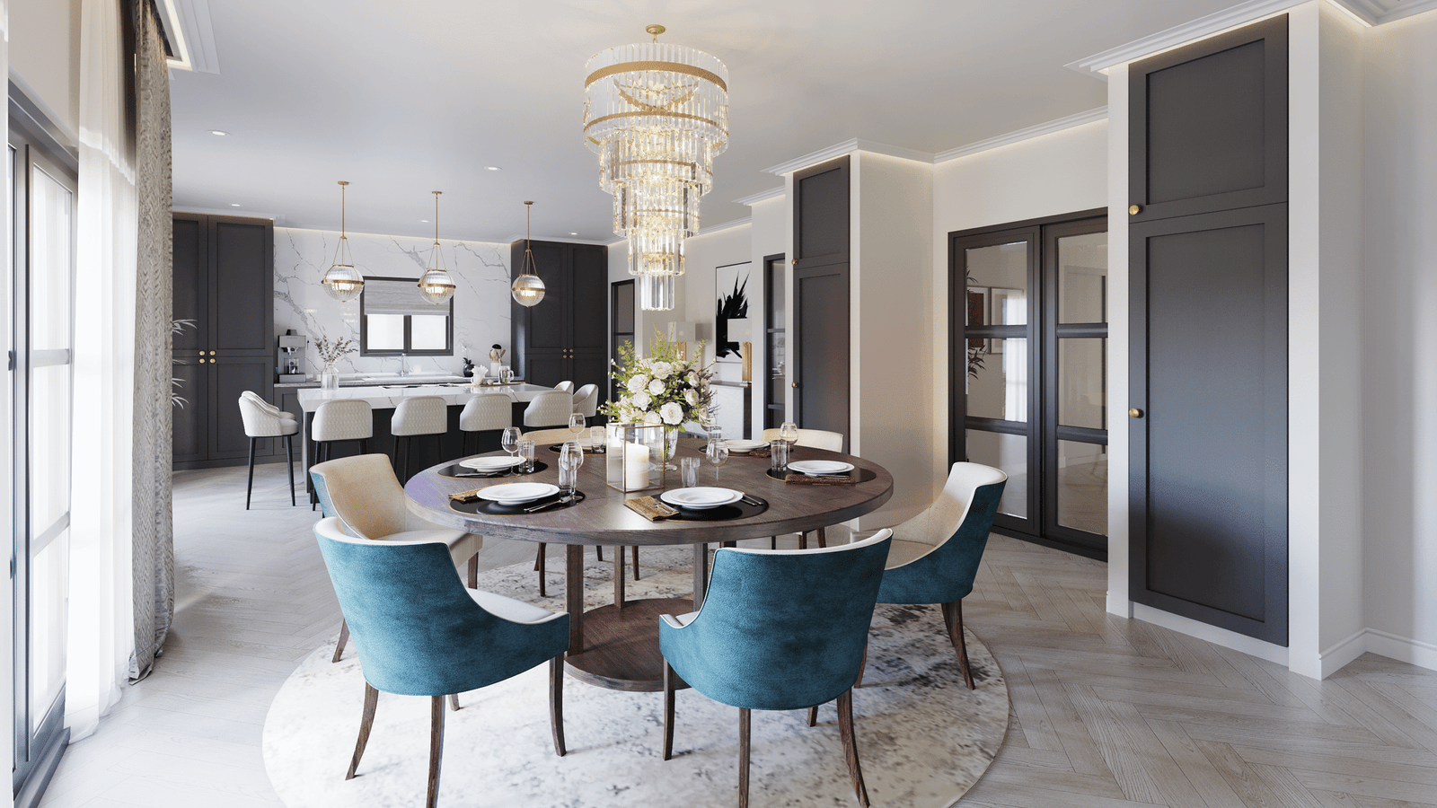 Modern dining room with round wooden table, teal upholstered chairs, crystal chandelier, marble flooring, and open kitchen layout.