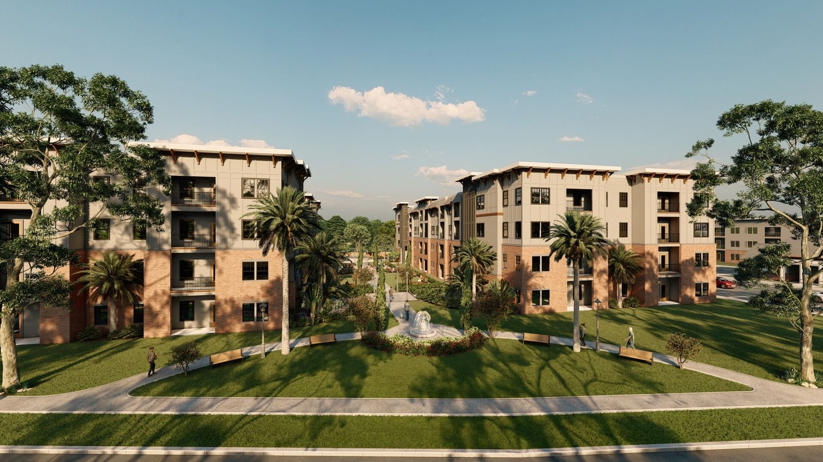 Aerial view of multi-building residential complex with central courtyard, trees, and parking areas