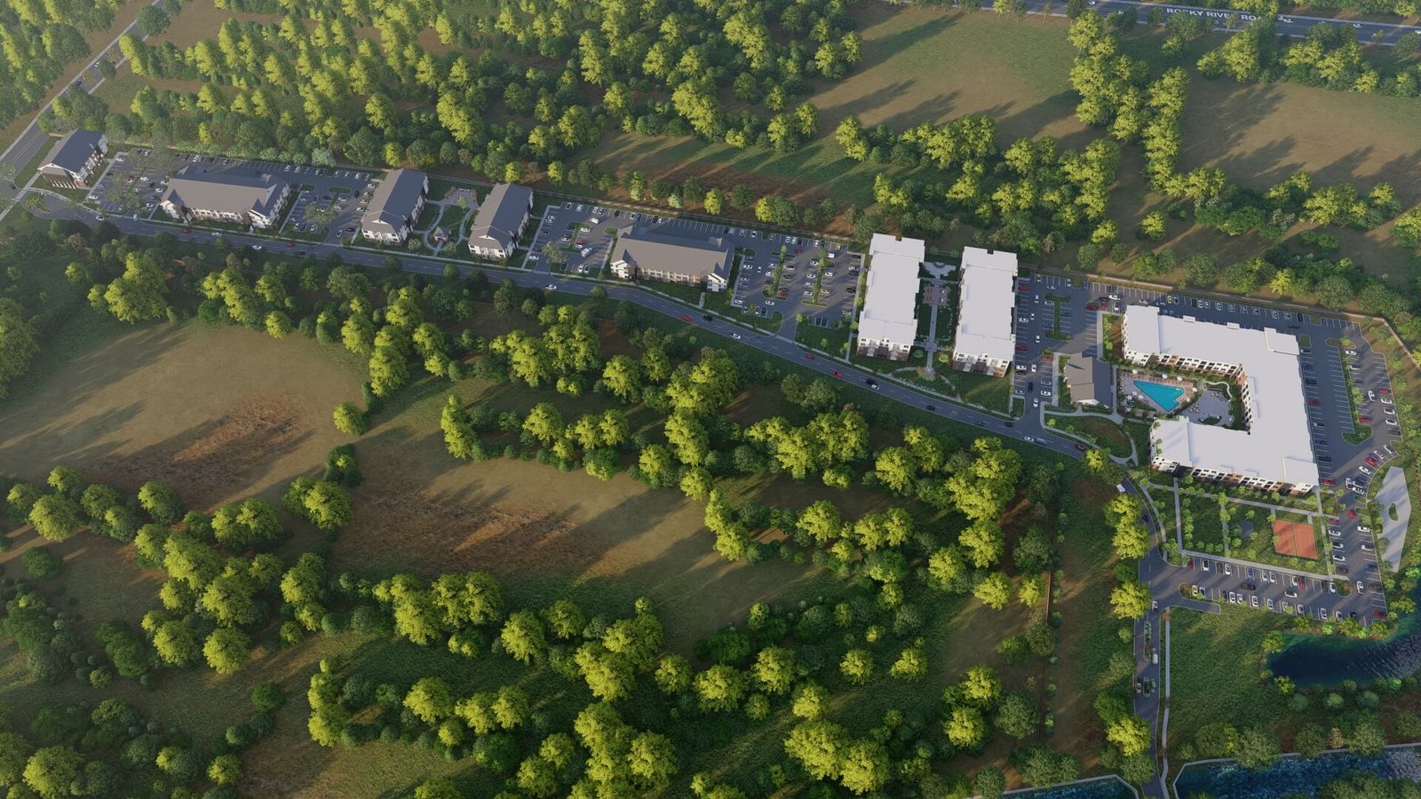 Aerial architectural visualization of a residential development showing building layout, roads, landscaping, and surrounding environment.