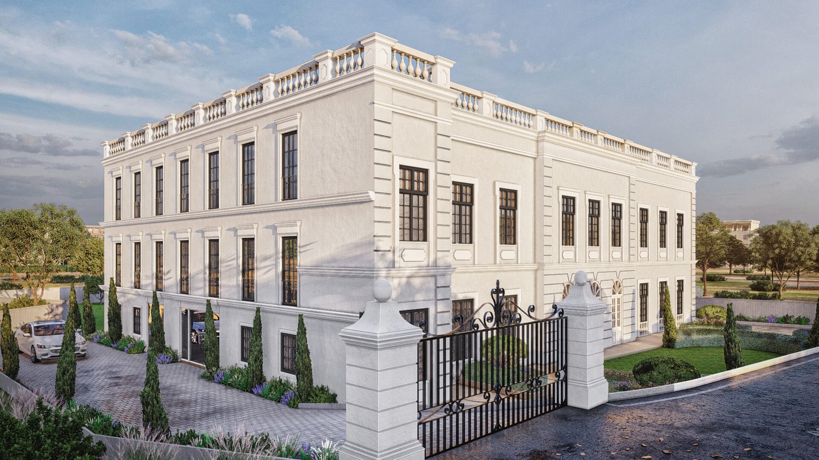 Neoclassical two-story mansion with balustrade parapet, symmetrical windows, decorative cornices, and wrought-iron entry gate with landscaped driveway.