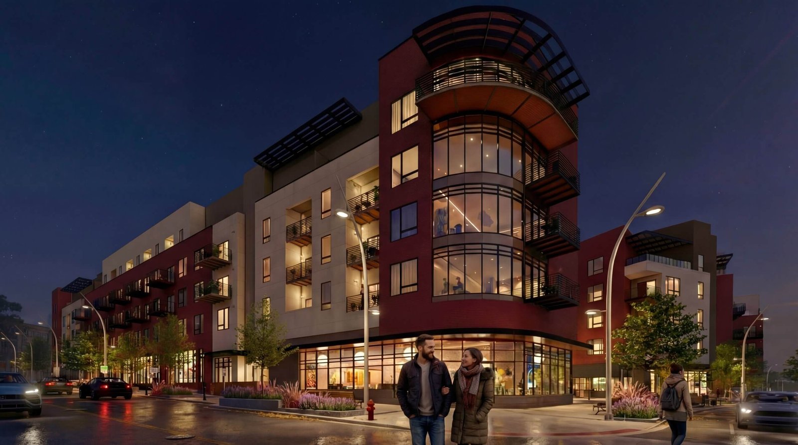 Modern mixed-use building exterior at night with illuminated apartments, retail spaces, street lighting, and pedestrians in an urban setting
