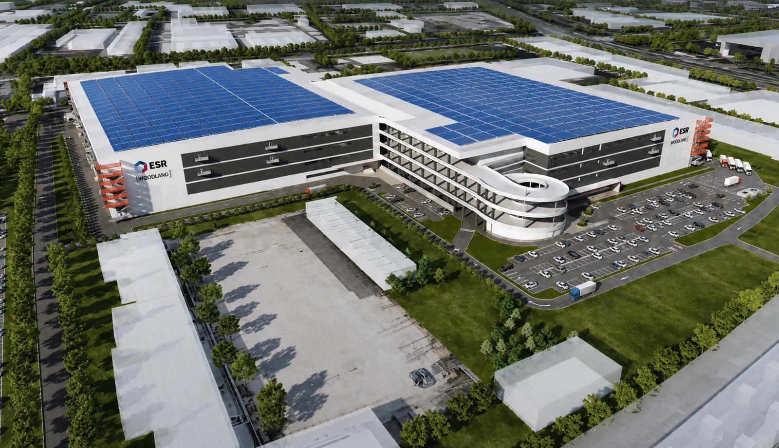 Aerial view of commercial warehouse complex with blue solar panels and surrounding landscape